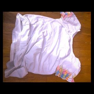 A white shirt with rainbow sleeves